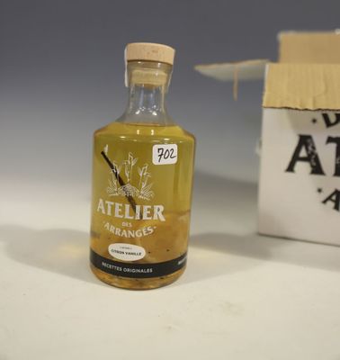a small bottle of alcohol sitting next to a box