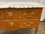 a marble top chest of drawers with gold handles