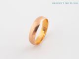 a close up of a gold ring on a white surface