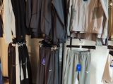 a lot of clothes hanging on a rack in a store