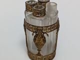 a glass container with a gold decoration on it