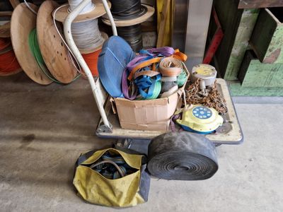 a cart full of various items in a garage