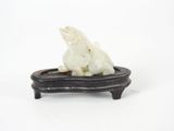 figurine of a polar bear sitting on a black tray