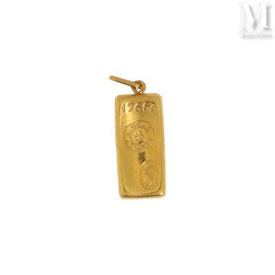 a close up of a gold pendant on a white background