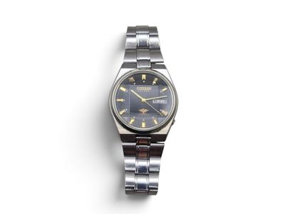 a close up of a watch on a white surface