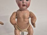 two old dolls that are sitting on top of a table
