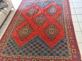 a red rug on the floor in a living room