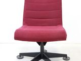 a red office chair that is sitting on a black base