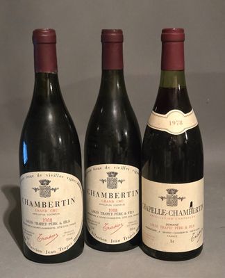 three bottles of wine are lined up on a table