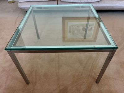 a glass table with a picture on it in a living room