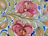 a blue and white plate with pink flowers on it