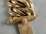 an image of a close up of a gold chain bracelet