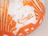 an orange and white plate with a design on it