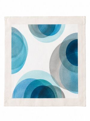a close up of a napkin with blue circles on it