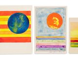 four different colored cards with different designs on them on a white surface