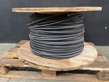 a wooden pallet with a large coil of wires on top of it