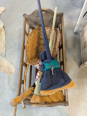 an overhead view of a broom and a broom on a wooden chair