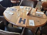 tables and chairs in a restaurant with a view of the street