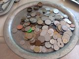 a bowl full of coins sitting on a table