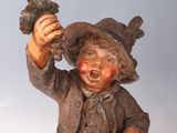 a statue of a boy holding a bird in his hand