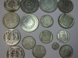 several different types of coins are arranged in a circle on a white surface