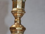 a gold vase that is sitting on a table