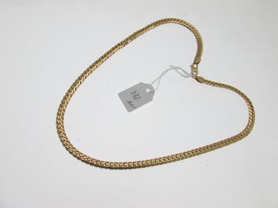 a close up of a gold chain with a price tag on it