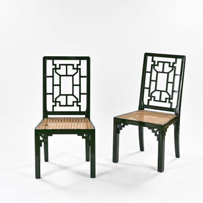 pair of black chairs with wicker seat and backrests
