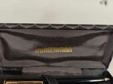 a box with a pen and a pen holder inside of it