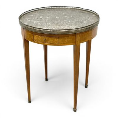 a round table with a metal top and wooden legs