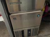 an image of a stainless steel ice machine in a garage
