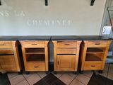 three wooden cabinets that are on wheels in front of a wall