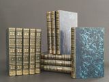 several books are stacked on top of each other on a table