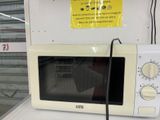 a white microwave sitting on top of a white counter