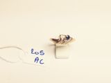 a close up of a ring on a white surface with a blue marker