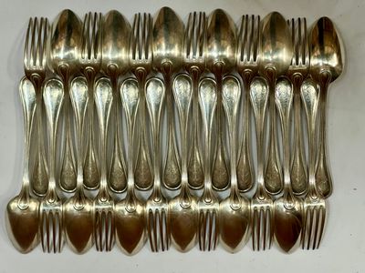 a lot of silver spoons and forks on a table