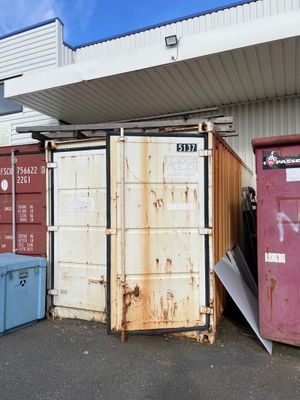 de nombreux conteneurs qui sont entreposés à l'extérieur d'un bâtiment
