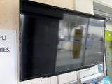 a television mounted on the wall in a store