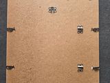 an overhead view of a piece of cardboard with screws attached to it