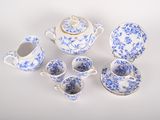 several pieces of blue and white porcelain tea set on a white surface