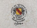 a white plate with a red and yellow emblem on it