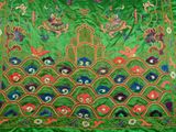 a close up of a green cloth with colorful designs on it