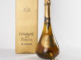 an image of a bottle of champagne next to a gold box