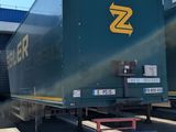 a truck that is parked next to a train