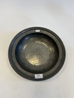 a close up of a metal bowl on a white surface