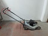 a small lawn mower sitting on the floor in a room