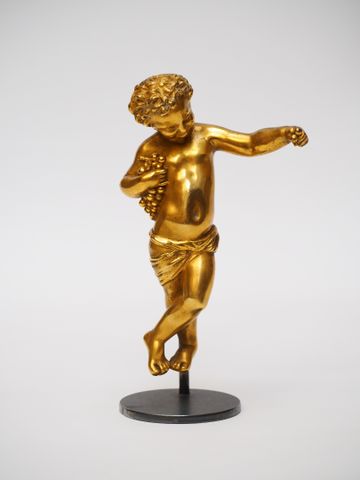 Petit bronze doré figurant Bacchus tenant des raisins, sur socle,...