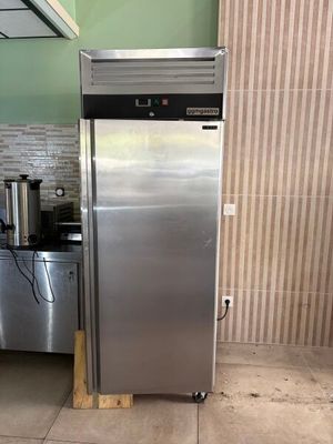 a stainless steel refrigerator in a kitchen with a coffee maker on the counter