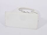 white purse with a ring on top of it on a white surface
