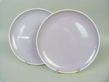 pair of purple dinner plates with gold rims on a white background